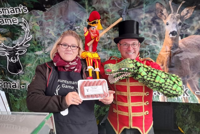 The crocodile finds the sausages at the farmers' market with Paul Temple and Mr Punch.