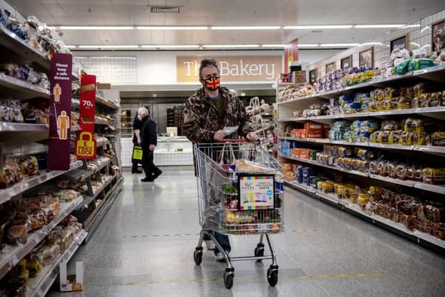 A man wearing a Union Jack flag design face mask shops in a Sainsburys supermarket. (Photo by Chris J Ratcliffe/Getty Images)