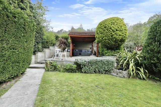 At the back of the bungalow sits this beautiful, enclosed and well-maintained garden, which includes a lawn and a lovely, paved, raised seating area.