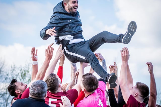 Players throw boss Craig Denton into the air after winning promotion.