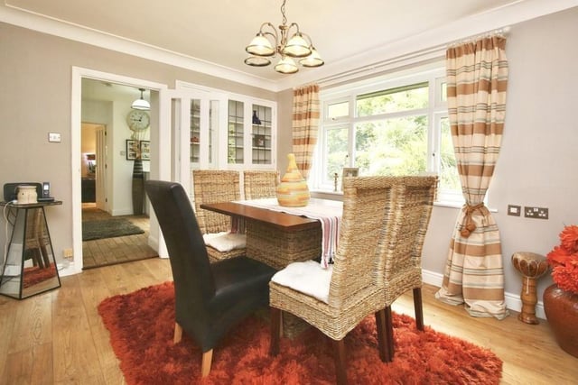 The second reception room at the Oldcotes cottage is this stylish dining room. It boasts wood-effect flooring, built-in storage with a feature display unit and a front-facing uPVC window.