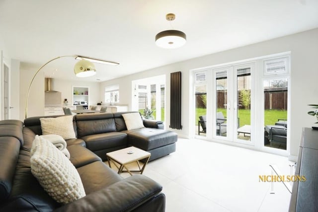 Here is the luxurious living space that is part of the open-plan kitchen. Two sets of doors lead out to the garden.