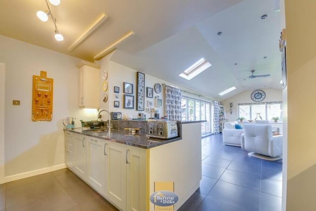 The kitchen, which filters seamlessly into the sitting-room extension, has underfloor heating. There is also plumbing for an automatic washing machine.
