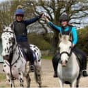 Mother and daughter, Anita Marsh and Alyssia riding together to train their young horse.