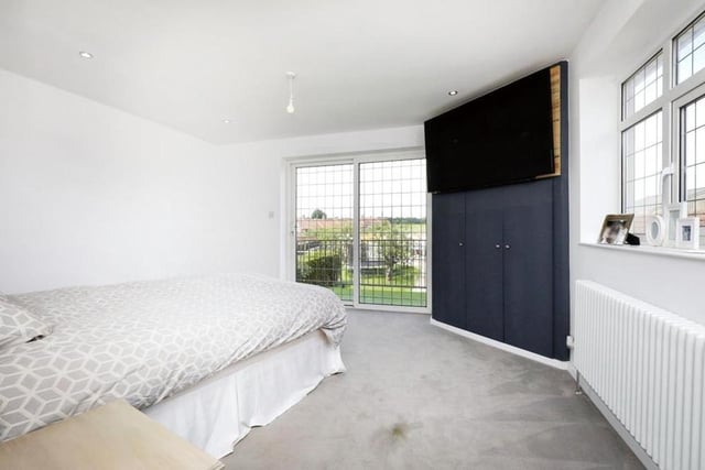 The most eyecatching feature of the first bedroom is a double-glazed patio door that leads on to a balcony, offering superb views of the back of the £580,000 house. A window faces the side, while the rest of the room includes spotlights, a built-in wardrobe and a recess for a giant TV.