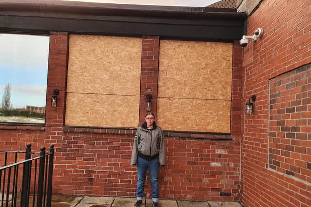 Maltby's Queen's Hotel manager Beth Burns beside boarded-up windows at the pub
