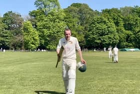 Dave Beard walking off the pitch after scoring 65 runs for Clumber Park against Milton.