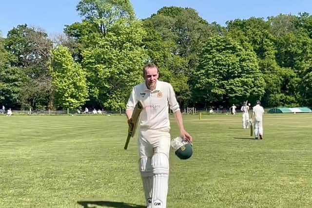 Dave Beard walking off the pitch after scoring 65 runs for Clumber Park against Milton.