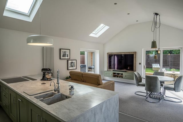 Let's start our tour of the £475,000 Shireoaks bungalow in the heart of the home, which is an open-plan centrepiece that encompasses a bespoke kitchen, dining room and living space. It has a striking vaulted ceiling.
