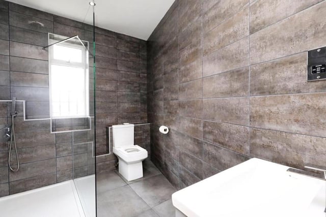 The first bedroom has access to this stylish en suite, which consists of a large walk-in shower, vanity wash hand basin and low-level WC. Not to mention a central-heating towel-radiator, tiled flooring and spotlights to the ceiling.