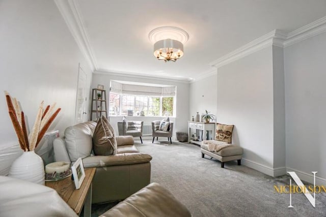 The lengthy living room at the £550,000 property is a modern, well-proportioned space. Expertly appointed and decorated, it has a front-facing uPVC, double-glazed bay window, coving to the ceiling, a cast-iron central heating radiator, power points and a TV point.