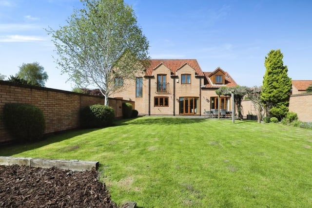 This photo gives a good view of the rear of the £660,000 property, with the balcony in the master bedroom and the ground-floor doors that open out to the sizeable garden.