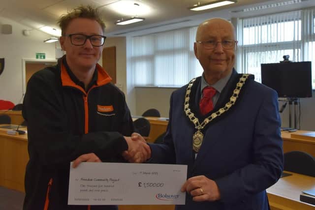 Coun Tom Munro, Bolsover Council chairman, right, presents Mark North, from the Freedom Project, with a cheque for £1,500.