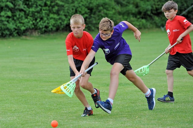 A competitive Pop Lacross tournement action between Mansfield's St. Philip Neri (purple) and Worksop's Sparken Hill Academy.