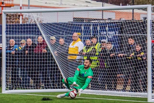 Seb Malkowski saves a penalty in the shootout against Ramsbottom United in the FA Trophy. Pic by Lewis Pickersgill.