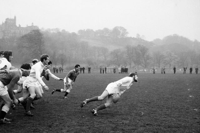 Edinburgh University rugby player JP Hartley passes the ball out from a loose maul during a match against the Co-Optimists at Craiglockhart in 1964.