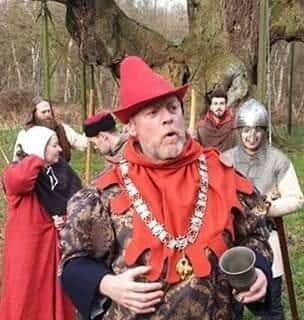 The Sheriff of Nottingham with the band of outlaws by the Major Oak in Sherwood Forest