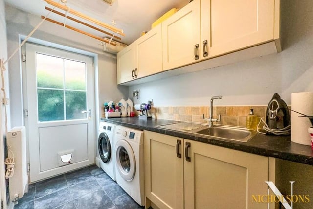 Just off the kitchen is this utility room, with spade and plumbing for a washing machine and tumble dryer. Base and wall units match those of the kitchen, while the sink is stainless steel with drainer.