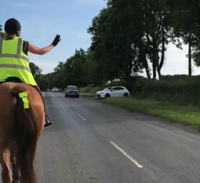 Rachael Wilsey signals to the driver on the B1403 betweeen Misterton and Gringley-on-the-Hill.