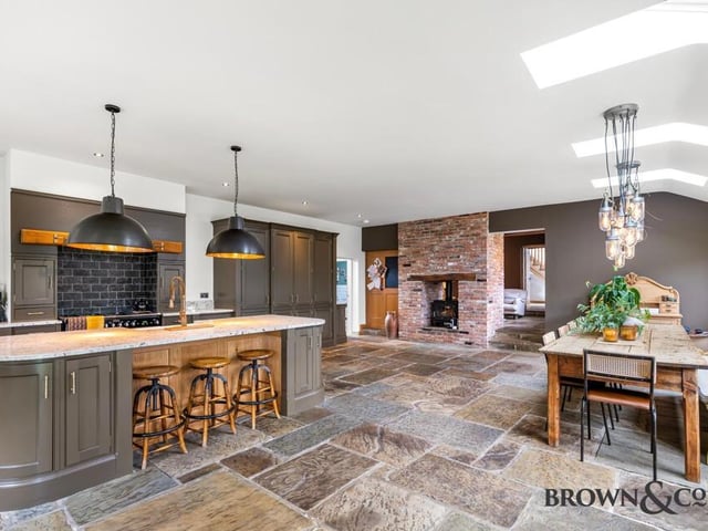 The stunning living and dining kitchen, that has doors to outside.