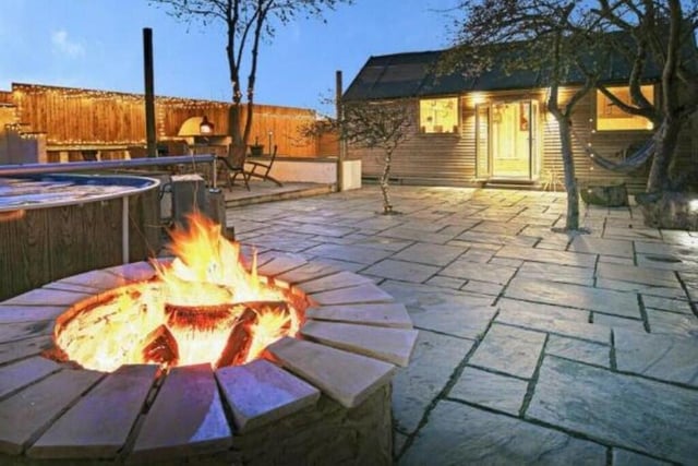 Another evening picture shows the garden's fire pit, glowing magnificently.