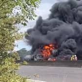 Smoke billows from the huge tanker fire which has caused the M1 to close in both directions