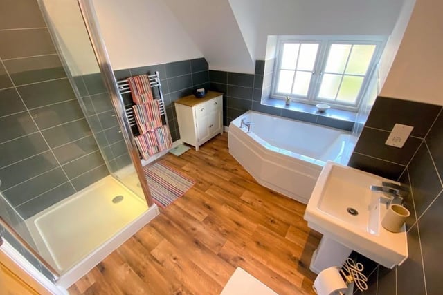 Before we move on to the third bedroom, let's take a look at the family bathroom. A lovely space, it features a four-piece suite with a fitted corner bath, separate shower cubicle, WC and pedestal wash basin, not forgetting a heated towel-rail and extractor fan.
