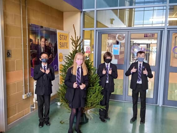 Students at Outwood Academy school in Worksop with the donated Christmas tree.