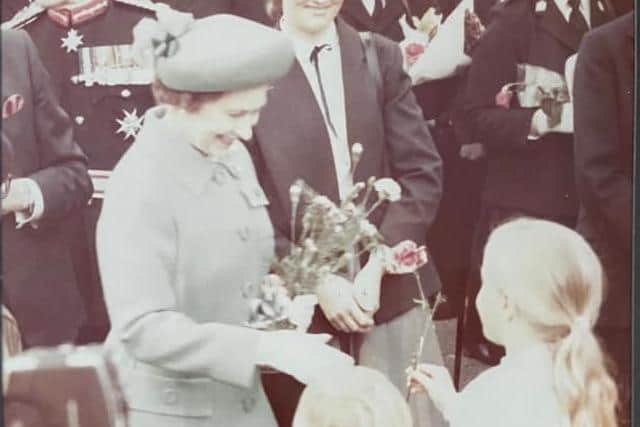 Anna Mallinson, from Sparken Hill, pictured at age nine, giving the late Queen Elizabeth II a flower in Worksop, 1981. Picture: Tony Caseldine