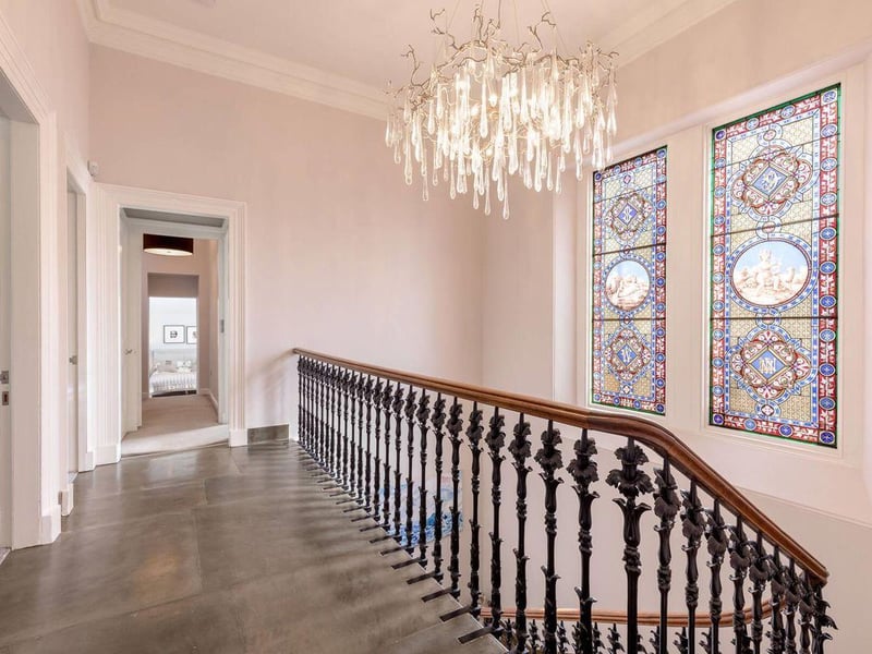 First floor landing with stained glass windows.