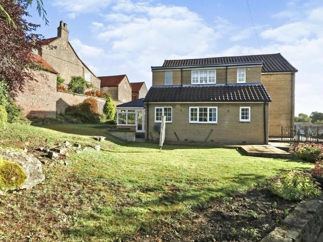 Back outside, we see how extensive the garden is. A lawned area extends from the side of the property to the back.