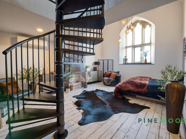 The main bedroom, with spiral staircase to a mezzanine level.
