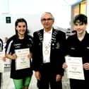 Swim England East Midlands President David Rush presents certificates to record holders Sophie Smith, Lucy Conroy and Luke Baughan-Withington.