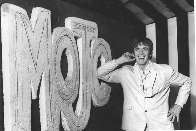 The famous nightclub boss Peter Stringfellow with the sign to his Mojo club in 1965