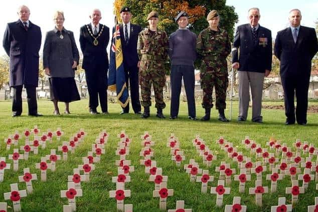 Standard bearer Brian Madden (fourth from left) in a field of remembrance at the start of another Poppy Appeal in Worksop several years ago.