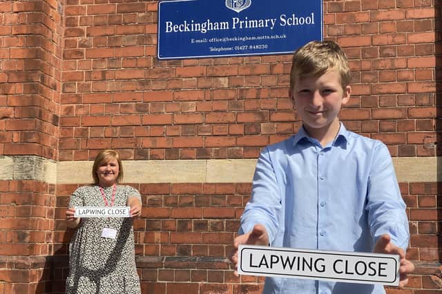 Year 6 Beckingham Primary School pupil Harrison, proudly displays his winning street name with Charlotte Kirk, Head of Sales for Albemarle Homes.