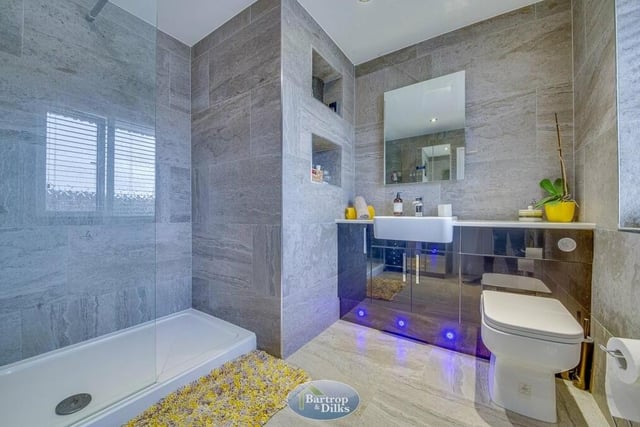 The main bedroom has access to this superb, contemporary en suite shower room. Recently refitted, it boasts a double walk-in shower area, low-flush WC, wash hand basin set within a vanity unit, tiled floor and walls, heated towel-rail and heated, wall-mounted Bluetooth mirror.