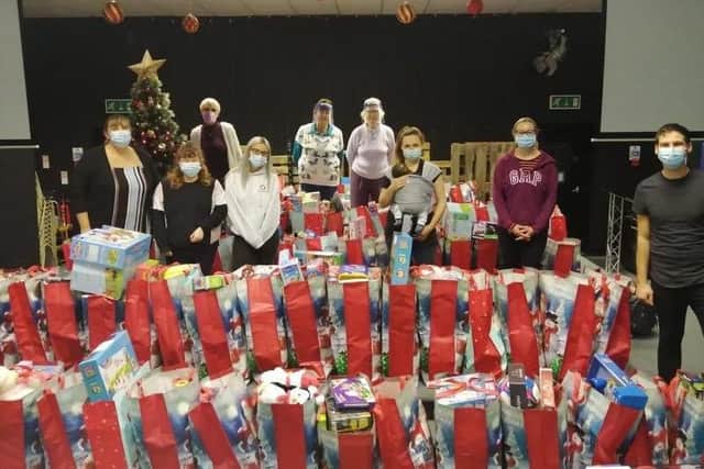 From The Heart Charity and Now Church volunteers helping to pack 150 bags of toys for the community