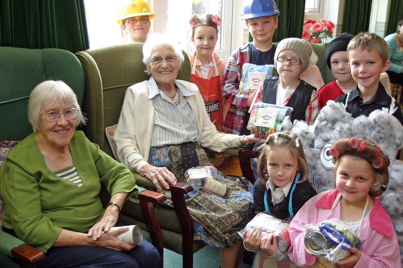 Children from Kensington Junior School visit the residents of Hargreaves Court on Nottingham Road in 2009 to deliver harvest parcels and perform the play Little Black Cloud.