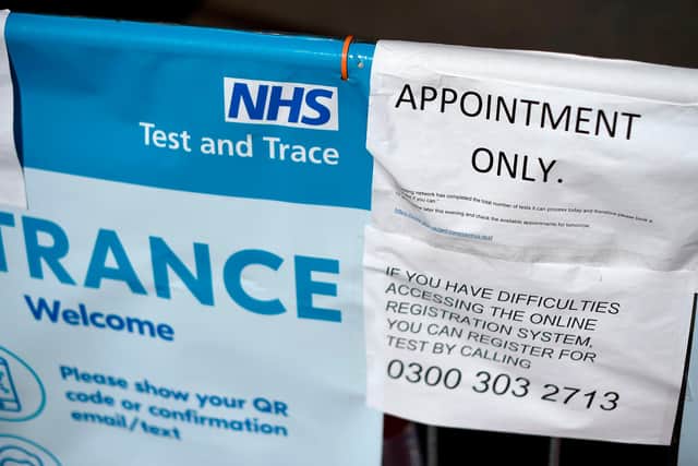 A sign advises members of the public that COVID-19 testing is "by appointment only", and suggests they should book a home-testing kit instead (Photo by DANIEL LEAL-OLIVAS/AFP via Getty Images)