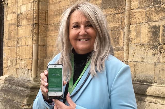 Councillor Sue Shaw pictured with the new TrailTale app, available on the app store now.