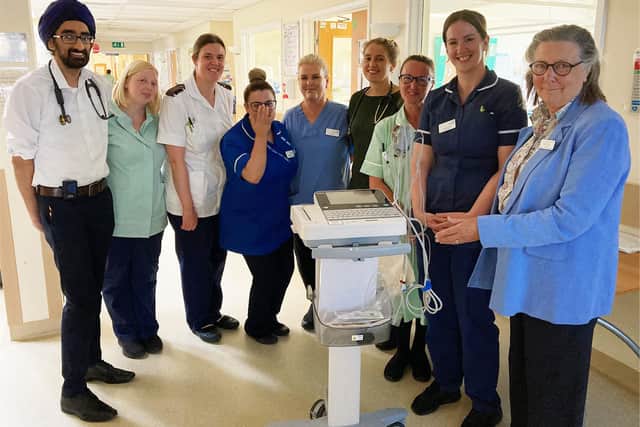 Colleagues on Ward A4 with Philippa Farr, President of the League (far right) presenting the ECG machine.