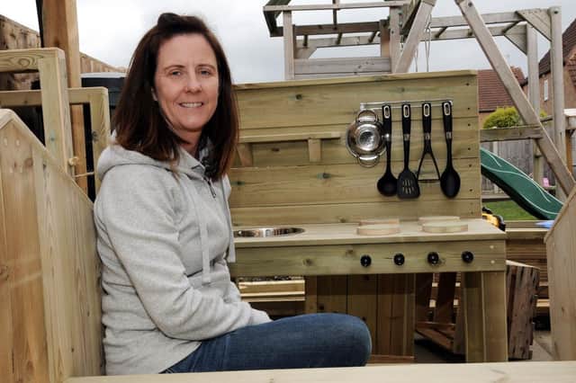 Tamara Hazlehurst in an outdoor kitchen which she has created using sustainable wood.