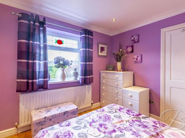 It's pretty to look at - and it's a pretty good size too! That's the first bedroom at the Pump Hollow Lane bungalow. It boasts laminate flooring, a central heating radiator and a window overlooking the front of the property.