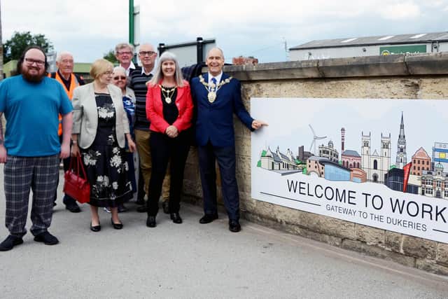 Worksop Mayor Tony Eaton officially unveils the new sign at Worksop Station.