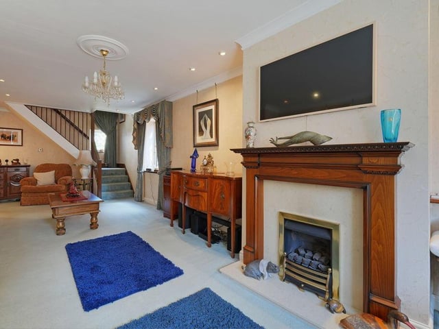 A spacious living room with feature fireplace.