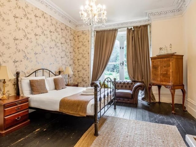 Also on the ground floor of the property is one of the eight bedrooms. Like most rooms in the house, it is bright and spacious.