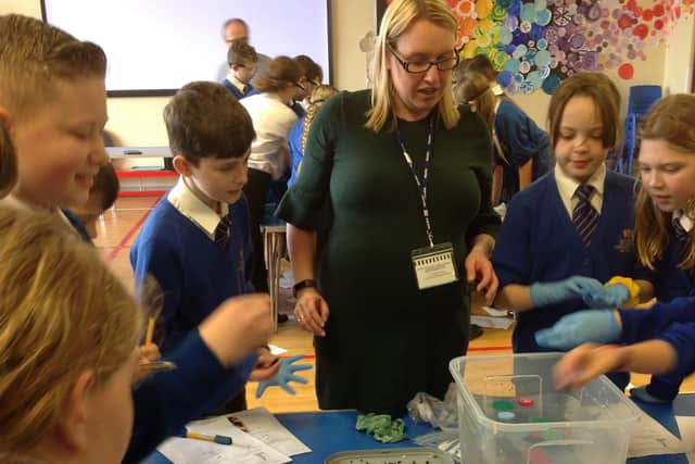 Staff from MBA Polymers UK, in Worksop, work with children at St John's Academy.
