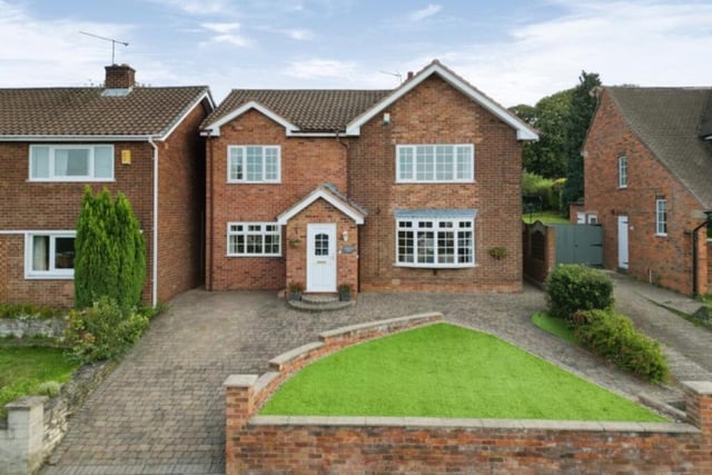 The last photo in our gallery shows the front of the £540,000 property. It features a lawn of artificial grass and a block-paved driveway, offering off-street parking space.