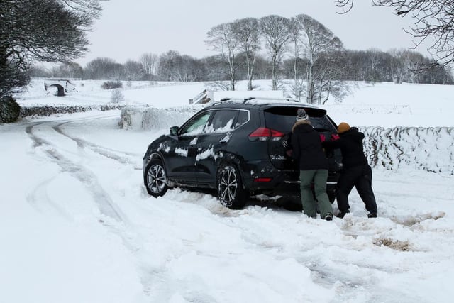 A Nissan X-Trail gets a helping hand after getting in the Derbyshire Peak District near Biggin.